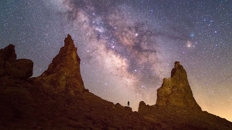 The Milky Way core rising over a landscape